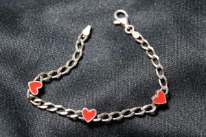 lot 55 image: Sterling Silver Italian bracelet with enamel station in heart form. 6L. Marked 925 Italy REEB on clasp. 5.4 gr approx