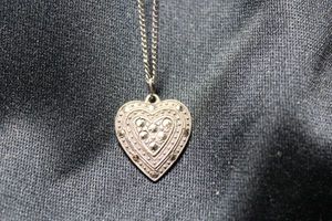 lot 56 image: Sterling Silver marcasite heart pendant on a 16L cable chain. Pendant marked sterling on reverse. Chain unmarked. 4.4 gr approx