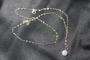 lot 58 image: Sterling Silver double strand sequin link bracelet with faux diamond charm. Marked 925 on lobster clasp. Adjustable from 9-10L.