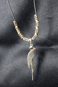 lot 60 image: Sterling Silver MCM modernist dangle tassel pendant (marked 925) on a 17 corded necklace with 1 extender decorated with filigree barrel metal beads. Pendant is 2L