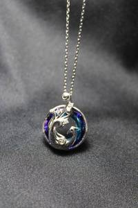 lot 64 image: Sterling Silver 3 dimensional disc pendant with figural peacock and blue glass background on a sterling silver pull-adjust necklace. Necklace is 28L with adjustable extension up to 29L. Built in tension ball. Marked 925 on spring ring.