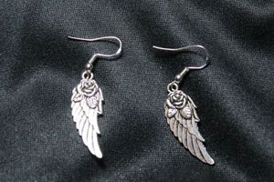 lot 66 image: Sterling Silver angel wing French ear wire earrings decorated with roses. 2L. Marked 925 on both ear wires. 4.8 gr approx