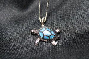 lot 72 image: Sterling Silver box chain 16L necklace with faux opal decorated pendant in turtle form. Necklace and pendant both marked 925. Pendant is 1L. 5.6 gr approx