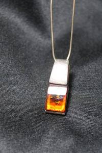 lot 78 image: Sterling Silver snake chain 16L necklace with sterling and Amber modernist pendant. Both marked 925. Pendant is 1.25L. 7.0 gr approx