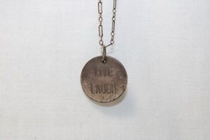 lot 87 image: Signed Sterling Silver long and short link chain necklace with disc pendant inscribed LOVE LAUGH LIVE. Necklace marked 925 with a CLK jewelry hang tag and heart dangle. 6.7 gr approx