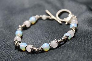 lot 88 image: Sterling Silver Moonstone and Quartz bead station bracelet with turtle dangle. Marked sterling with hallmark on back of turtle. Toggle clasp. 7L.