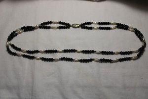 lot 101 image: Vintage double strand black bead and freshwater potato pearl necklace. 18L. Safety clasp.