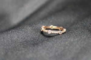 lot 103 image: Sterling Silver vermeil (gold over sterling) accented band ring. Size 5. Marked 925 AM on side.