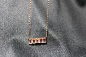 lot 105 image: Sterling Silver rose gold vermeil necklace with incorporated pink crystal or glass baguette pendant. 15L with 2 extender. Marked 925 on spring ring clasp.