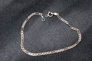 lot 107 image: Sterling Silver long and short link 7L bracelet. Has jump ring for charm near clasp. Marked 925 Mex on clasp.