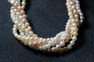 lot 114 image: Vintage multi color freshwater vintage pearl torsade necklace with sterling flower form clasp. Features 6 strands of multicolor pearls (white, peach, cream). Marked Silver on clasp. 16L