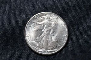 lot 115 image: 1945-D Walking Liberty half dollar. (90% silver content)
