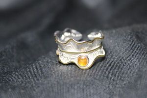lot 121 image: Sterling Silver and 18K gold peony leaf and bezel set brown Tourmaline gemstone ring. Sterling with 18K gold leaf edge accent. Marked S925 inside. Iconic peony leaf design. Size 8