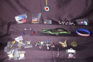 lot 328 image: Independence Day and patriotic jewelry. Includes a charm bracelet with 6 enamel charms, lapel pins, a double-sided articulating bicentennial pendant, and more.