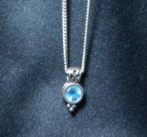 lot 130 image: Sterling Silver 18L curb chain with faceted blue pendant. Necklace marked sterling on spring ring. Pendant marked 925 AM. 8.6 gr approx