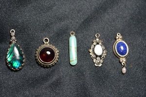 lot 125 image: (5) Sterling Silver pendants. All marked 925. Includes Turquoise, Abalone Shell, Blue Lapis, Mother Of Pearl and Amethyst.