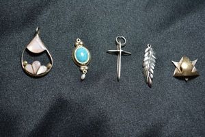 lot 126 image: (5) Sterling Silver pendants. All marked 925. Includes Mother of Pearl, cross, figural leaf and more.