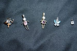 lot 127 image: (5) Sterling Silver pendants. All marked 925. Includes (2) birth month people, butterfly anchor and CZ solitaire.