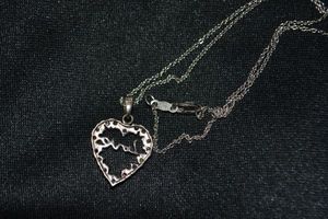 lot 135 image: Sterling Silver cable chain 15L necklace with diamond accent and multi gemstone heart LOVE pendant. Necklace marked 925 and pendant marked 925 RSE. 3.5 gr approx