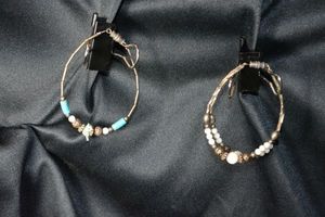 lot 138 image: (2) Sterling Silver silversmith artist created silver bead and gemstone bracelets. One has Mother of Pearl fetish bird and Turquoise. Other has Mother of Pearl round graduated sized beads. Both have barrel clasps. 7L approx. 10.7 gr approx