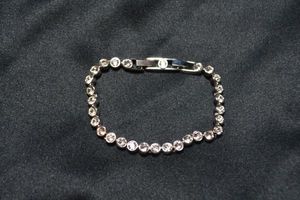 lot 144 image: Signed Swarovski crystal tennis bracelet. Marked Swarovski on clasp and with swan hallmark. 7.5L