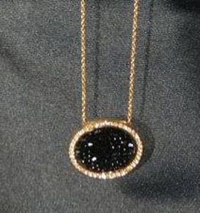 lot 143 image: Signed Swarovski gold plated necklace and Swarovski crystal disc pendant. Marked with swan logo in several places including hang tag. 16L.