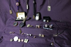lot 296 image: Gentlemens drawer lot. Includes 7 pairs of cufflinks, tie tacks including a King Tut tie tack, Atomic watch, military insignia pins, shark necklace, compass, vintage YMCA necklace, enamel Lions Club International bolo tie, leather band watch plus