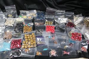 lot 323 image: (75) packages of sorted loose beads. Varying shapes, styles, colors, materials, sizes and quantities.