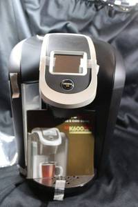 lot 132 image: Keurig K600 Plus Series Brewing System Coffee Maker. In working order, clean and with instruction manual. Uses K-cup Pod or carafe. Pet and child free home.