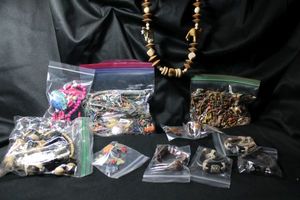 lot 331 image: Tribal animal theme necklaces (Elephant, Zebra, Giraffe, Fish), bracelets (elephant, Bee, Turtle), pin, and turtle silhouette earrings. Includes a resin raccoon face ring Size 9
