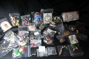 lot 340 image: Holiday & Christmas themed jewelry selection. Includes earring sets, necklaces, pendants, and brooches. Hallmark, Avon, Light up earrings and more