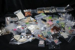 lot 351 image: (170) packages of sorted loose beads and pearls. Varying shapes, styles, colors, materials, sizes and quantities.