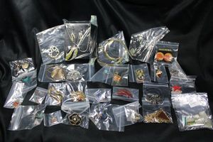 lot 355 image: (25) Enamel jewelry selection. Includes a replica LV charm bracelet and enamel pot leaf beads