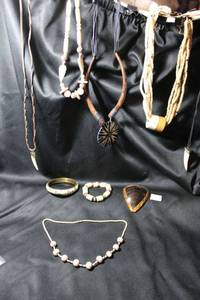 lot 334 image: Carved bone and bone bead jewelry. Includes an Ox bone pendant and wood and horn necklace.
