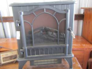 lot 100 image: Black electric stove heater, vintage toast master heat log