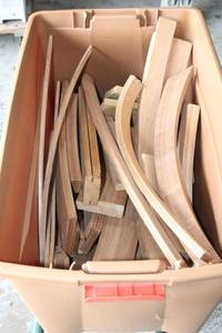 lot 8 image: 35 gallon latch tote with wood craft pieces