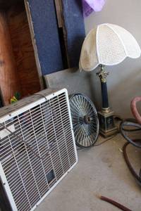 lot 38 image: Vintage table lamp, cane style lamp shade, bicycle wheel and box fan
