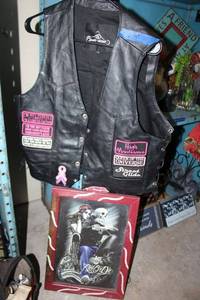 lot 51 image: Womens leather biker motorcycle vest size L with Ride or Die hanging picture