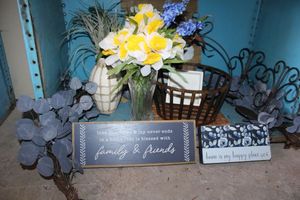 lot 52 image: Home decor Wall candle holders, metal basket, glass vases, blue plant artificial garland