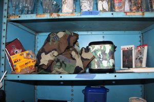 lot 54 image: US Air Force camo shirt, camo wireless speaker, Star Wars iphone cases for 67 plus, and Kodak film pack