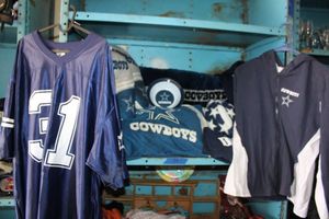 lot 59 image: Dallas Cowboys lot #31 jersey, Cowboys pants and jacket, pillows and bowls