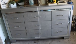 lot 83 image: Silver long dresser with mirror trim accents
