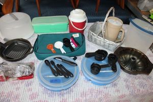 lot 19 image: Kitchen lot cast iron skillet, plastic storage containers, Bundt cake pan, silver plate items, steak knives