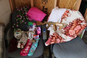 lot 105 image: Easter bunny socks, gloves, ceramic bowl, flower garland, floral curtain, wood toy Tommy Gun