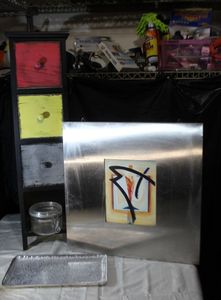 lot 22 image: Home Dcor Items BlackMulti Colored Drawer set (bottom drawer is missing) Square wall art by Alfred Gockel