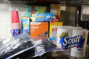 lot 49 image: paper products, plstic cups, ziploc bags, trash bags, toilet paper, contractor black bags