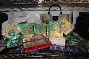 lot 68 image: Gift Ready Items SIP Pens, Burt Bees gift sets, perfum gift set, Andes Chocolate Mints, greeting cards and purses