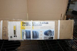 lot 121 image: Folding Wall Mount Tire Rack in Box