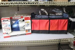 lot 131 image: Shark Retractor Handheld Vacuum, and auto organizer bag