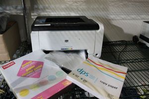 lot 137 image: HP Laserjet CP1025 printer with 2 reems copy Paper, a pastel and a white